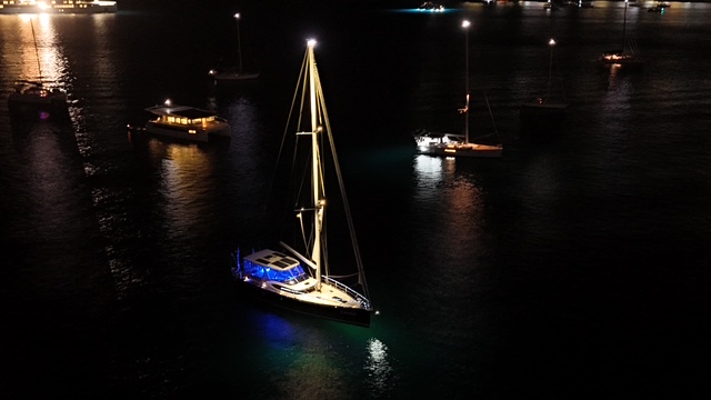 Exodus glowing at anchor at night