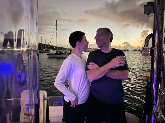 Couple sharing a quiet moment aboard at sunset