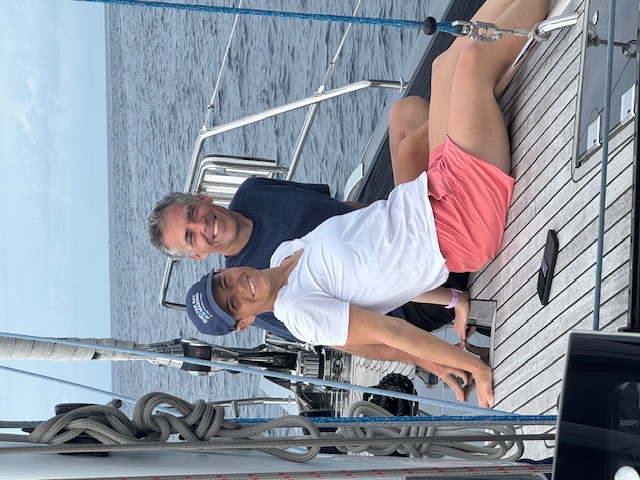 Couple relaxing on deck under sail