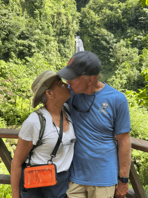 Couple kissing with a waterfall in the background