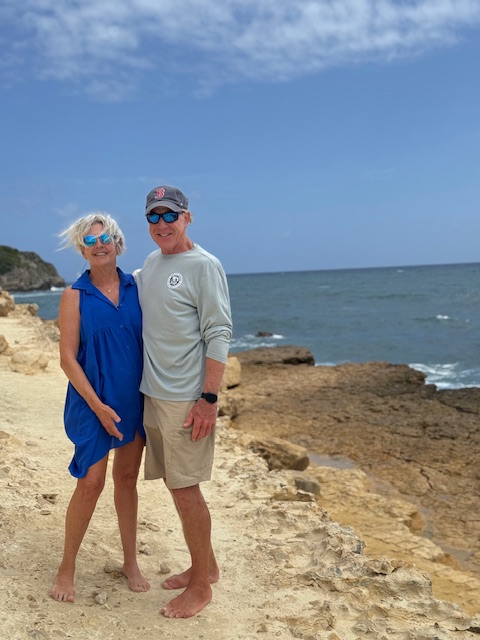 Couple standing on a rocky beach