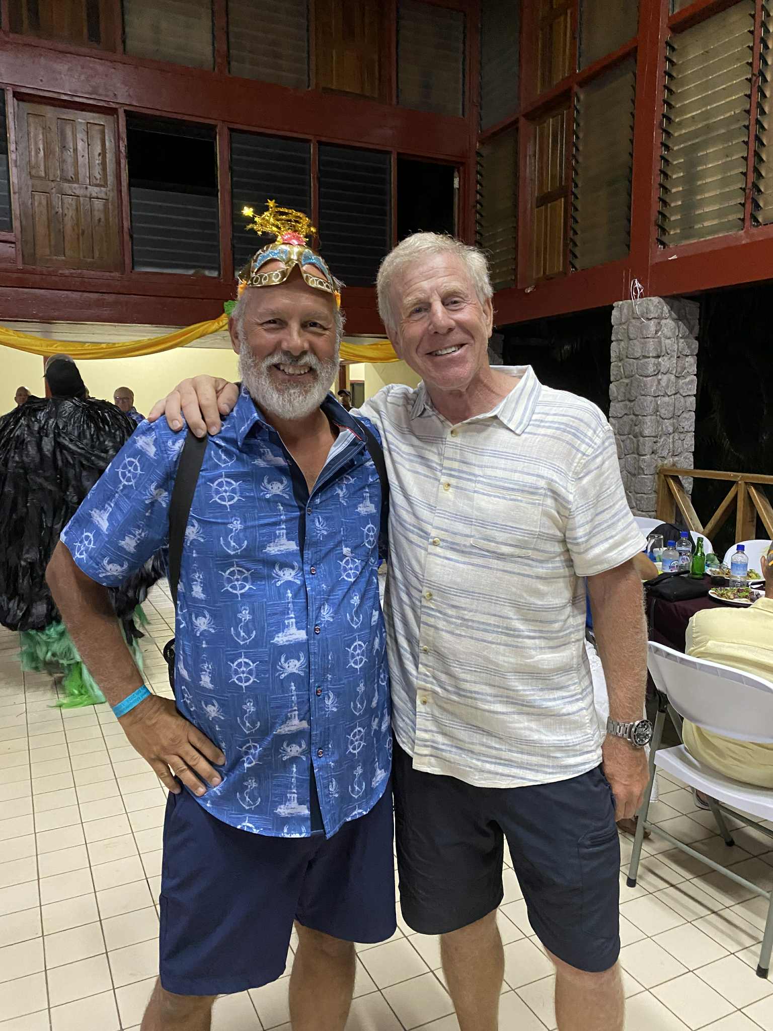 Two friends posing together at an evening gathering