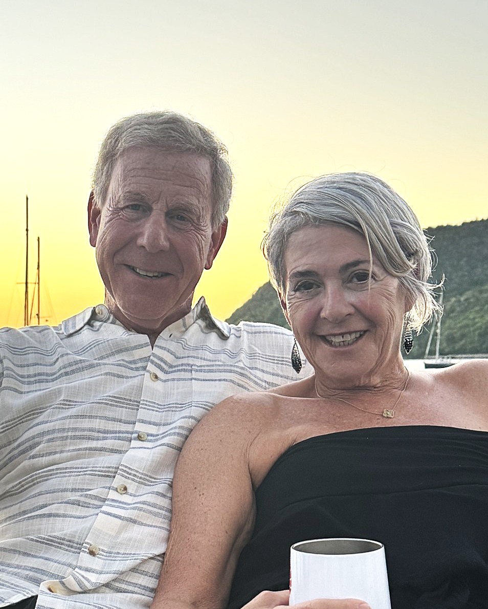 Couple enjoying sunset drinks by the water