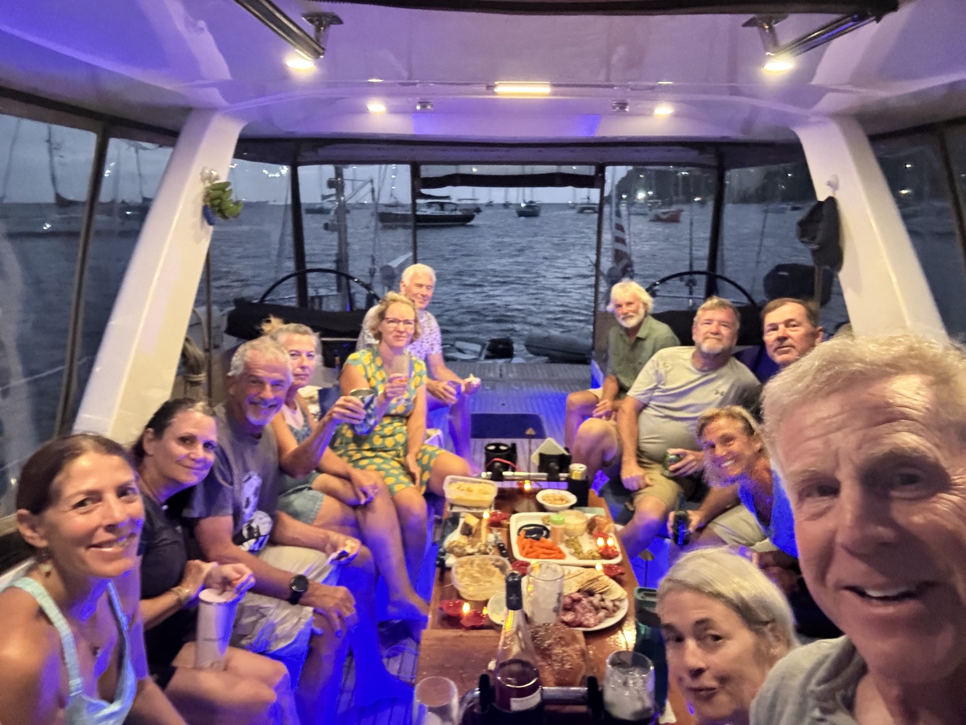 Guests gathered in the cockpit aboard Exodus at dusk